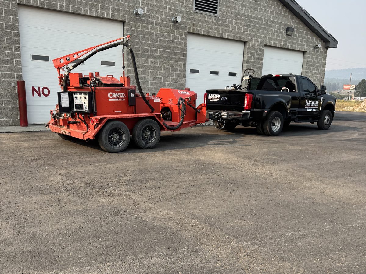 Service truck towing a Crafco hot-pour crack sealing unit
